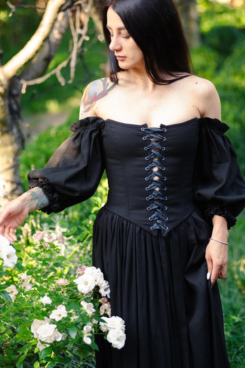 Off the shoulder black linen dress with structured corset, flowing skirt and puff sleeves