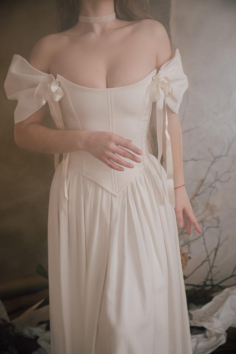 ivory renaissance wedding dress with corset bodice and puff sleeves off shoulder bridal gown