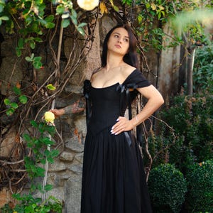Renaissance corset gown in burgundy velvet, styled with period-accurate accessories.