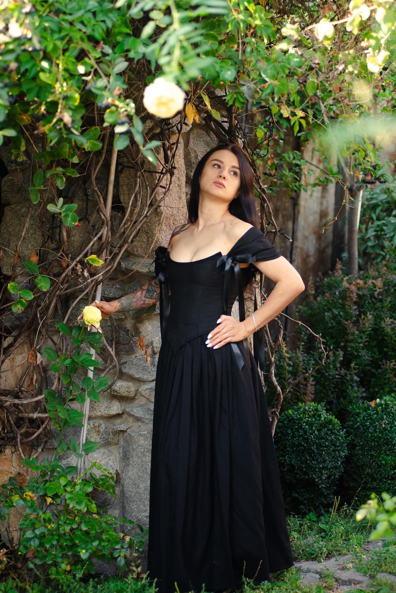 Renaissance corset gown in burgundy velvet, styled with period-accurate accessories.