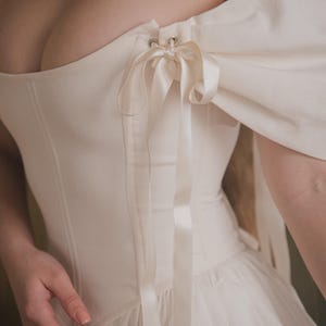ivory cottage style wedding dress with corset top and full skirt