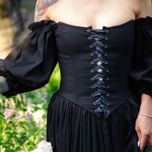 Full length black linen corset dress with romantic sleeves and fitted waist