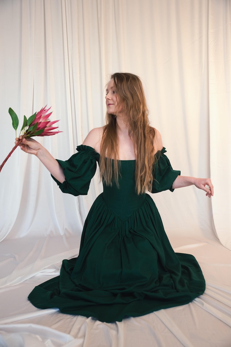 emerald green dress holding flowers cottagecore style