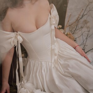 ivory renaissance wedding dress with lace up corset and flowing skirt
