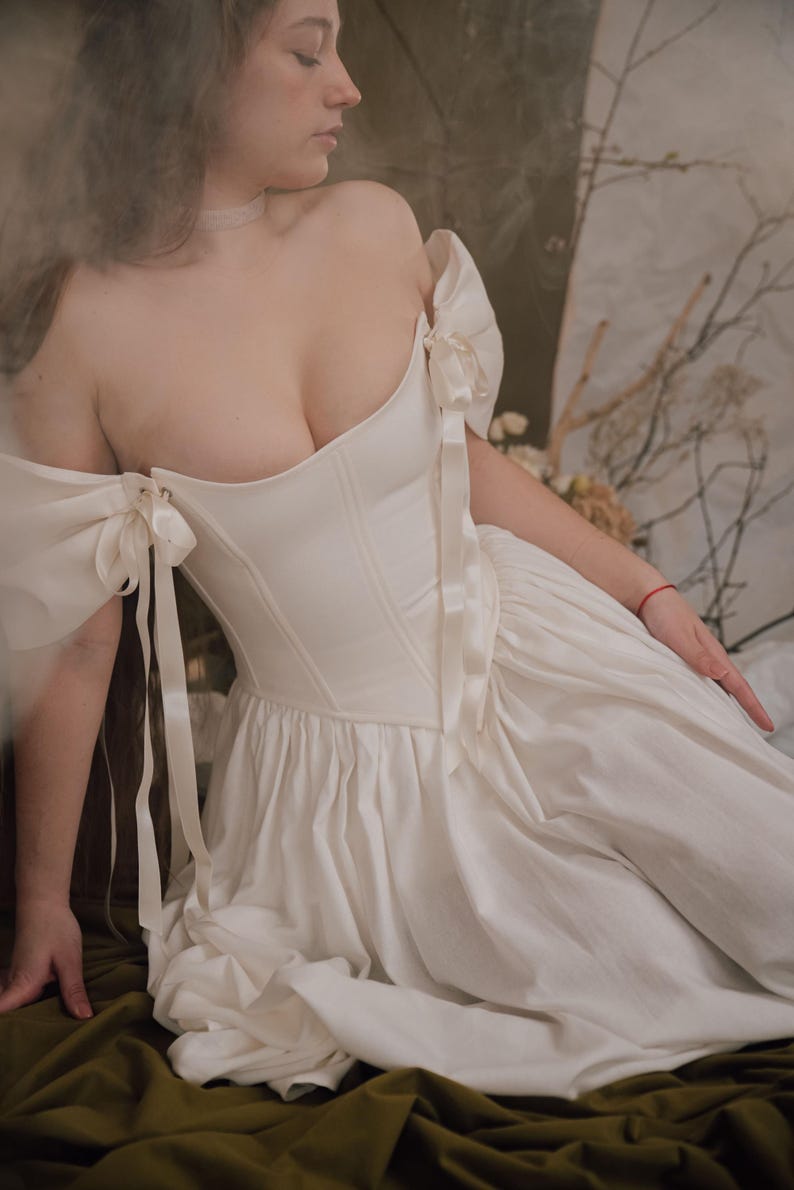 ivory renaissance wedding dress with lace up corset and flowing skirt