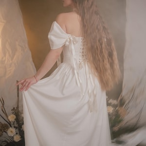 ivory medieval inspired bridal gown with off shoulder sleeves