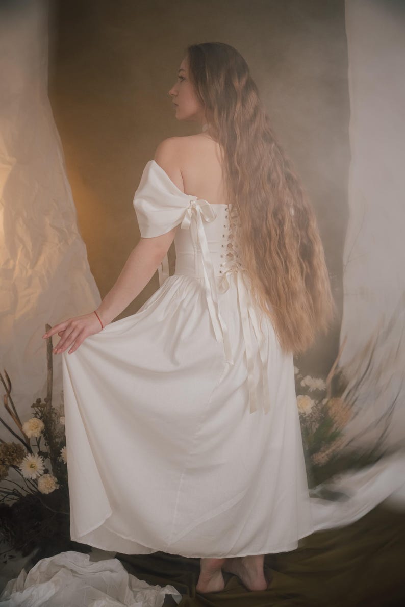 ivory medieval inspired bridal gown with off shoulder sleeves