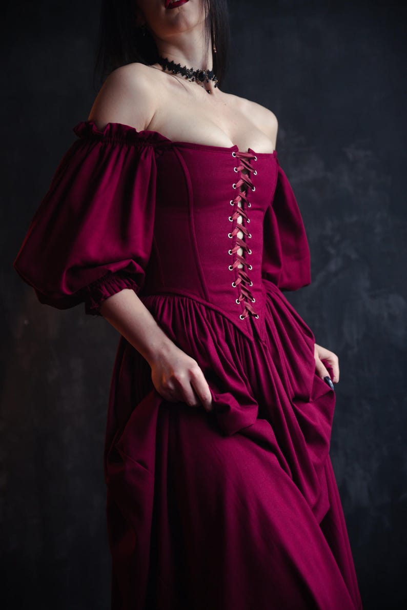 Burgundy renaissance corset dress with off the shoulder puff sleeves and flowing skirt