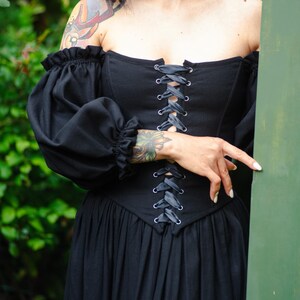 Elegant black corset dress with puff sleeves, historical renaissance silhouette