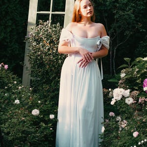 white linen wedding dress with corset bodice and off shoulder sleeves