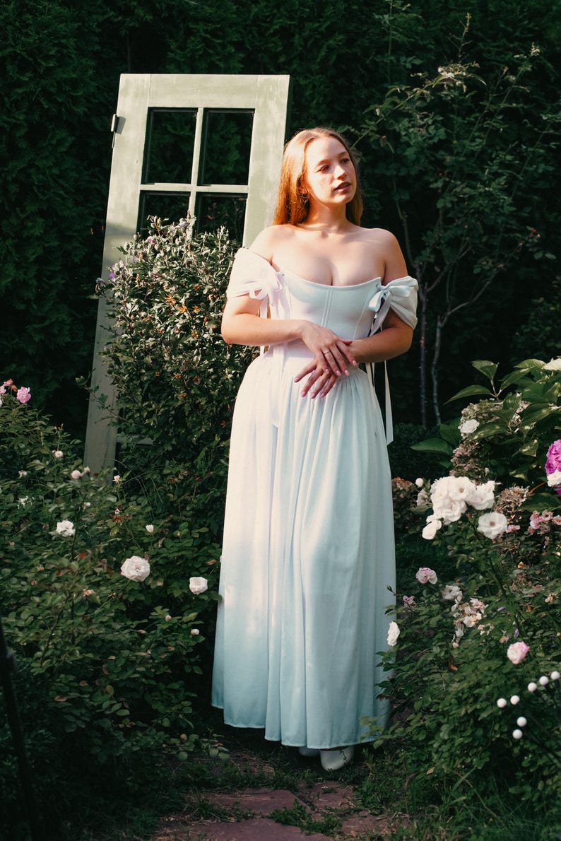 white linen wedding dress with corset bodice and off shoulder sleeves