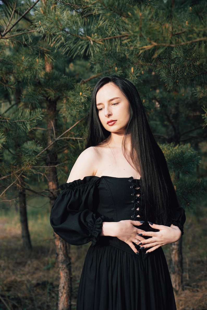 Black off the shoulder corset dress styled for forest wedding or fantasy photoshoot