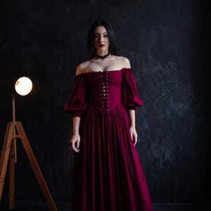 Deep burgundy corset dress in renaissance style, romantic silhouette and lace up bodice