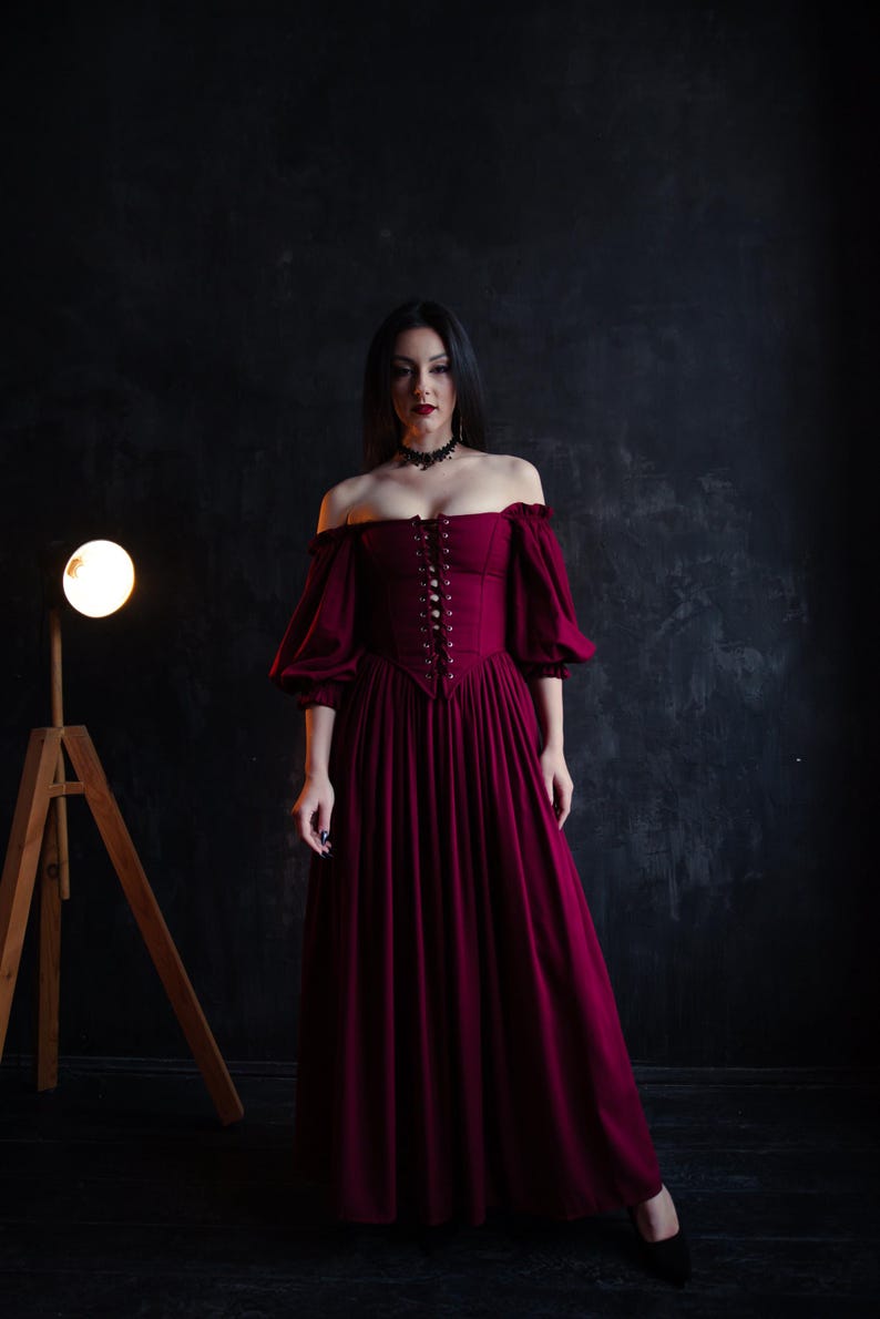 Deep burgundy corset dress in renaissance style, romantic silhouette and lace up bodice