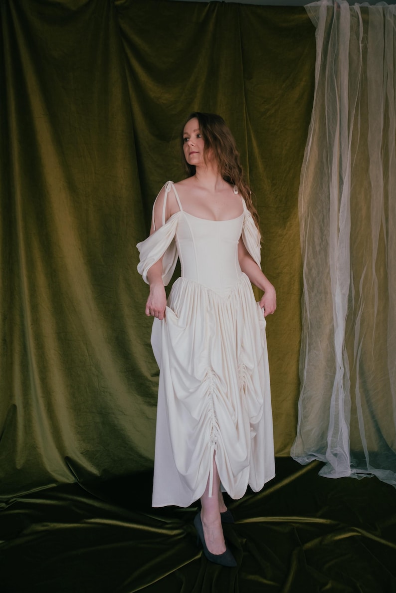 Corset wedding dress with ruched front skirt in ivory color