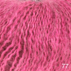 May include: Close-up of a pink fuzzy yarn. The yarn is soft and fluffy, with a slightly textured surface. The yarn is perfect for knitting or crocheting.