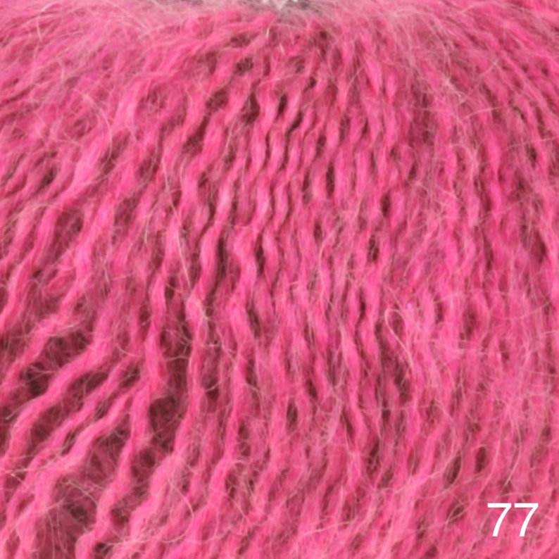 May include: Close-up of a pink fuzzy yarn. The yarn is soft and fluffy, with a slightly textured surface. The yarn is perfect for knitting or crocheting.