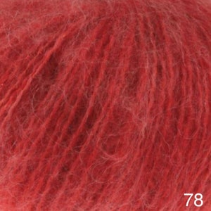May include: A skein of red yarn with a fuzzy texture. The yarn is labeled with the number 78.