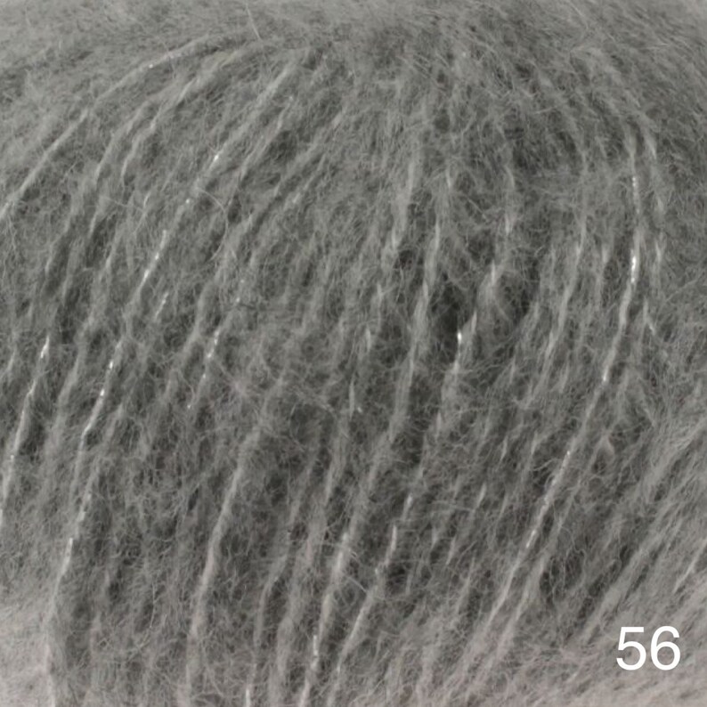 May include: Close-up of a gray yarn with a subtle shimmer. The yarn is soft and fluffy, with a delicate texture.