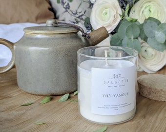 Può includere: Una candela bianca in un barattolo di vetro con un'etichetta che recita "Saugette Seulement Nature The D'Amour Bougie Artisanale Parfumee Sans Phtalates Sans Cire  | Fait Main en France 200 gr". La candela è su un vassoio di legno con una teiera e foglie di eucalipto.