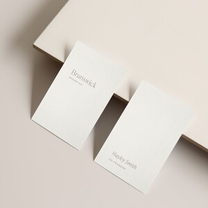 May include: Two white business cards with grey text. The top card reads "Brunswick Design Co." and the bottom card reads "Hayley Smith Co-Founder."