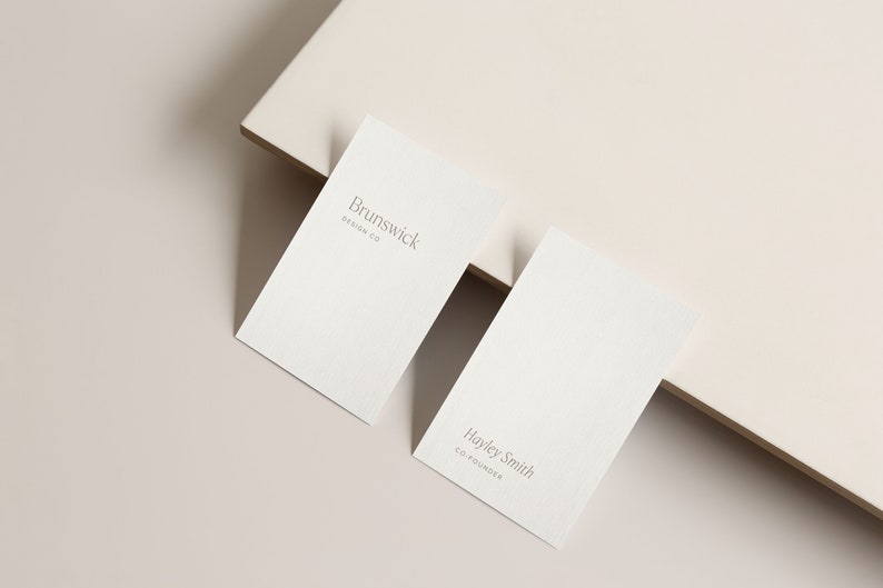 May include: Two white business cards with grey text. The top card reads "Brunswick Design Co." and the bottom card reads "Hayley Smith Co-Founder."