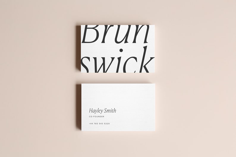 May include: Two white business cards with black text. The top card has the text "Brunswick" in a stylized font. The bottom card has the text "Hayley Smith, Co-Founder, +44 765 943 3220".