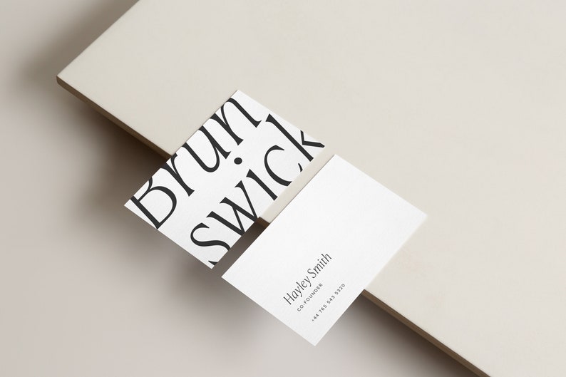 May include: Two white business cards. The top card has the word "Brunswick" repeated in a diagonal pattern. The bottom card has the text "Hayley Smith, Co-Founder, +44 7703 583 530".