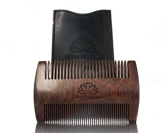 May include: A dark brown wooden beard comb with a black leather case. The comb has a logo that says "White Naturals" and a lotus flower design.