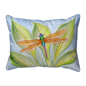 May include: A blue and green dragonfly with orange wings is perched on a green leaf with a light blue background. The pillow is decorated with a watercolor painting of the dragonfly.
