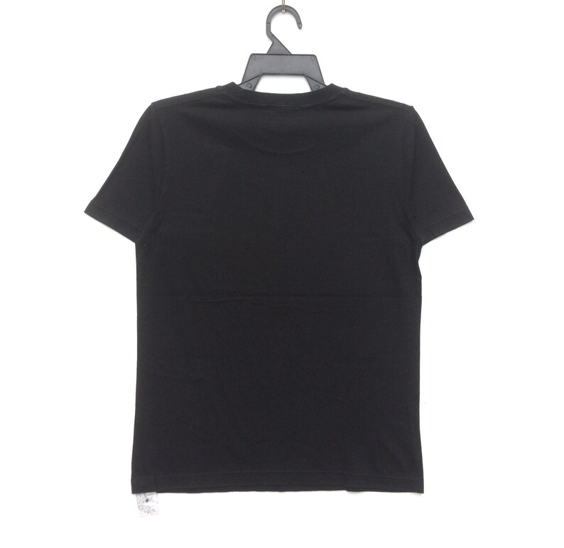 May include: A plain black t-shirt hanging on a black hanger. The short-sleeved shirt is made of a soft material and is displayed against a white background. The back of the shirt is visible.