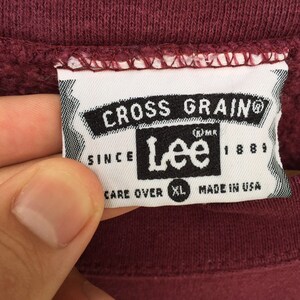 May include: A white tag with black text that reads "Cross Grain&reg;" and "Lee&reg; since 1889". The tag also says "Care Over XL Made in USA".