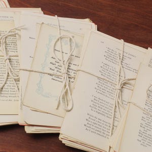 May include: A stack of vintage paperbacks tied together with twine. The pages are yellowed with age and the text is printed in black ink. The books are a mix of poetry and prose.