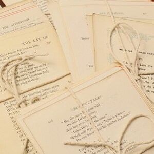 May include: A stack of vintage books tied together with twine. The books have various titles and text, including "The Lay of", "Our Village", "Ru Kiyat Omar Khayyam", and "Trutiful James".