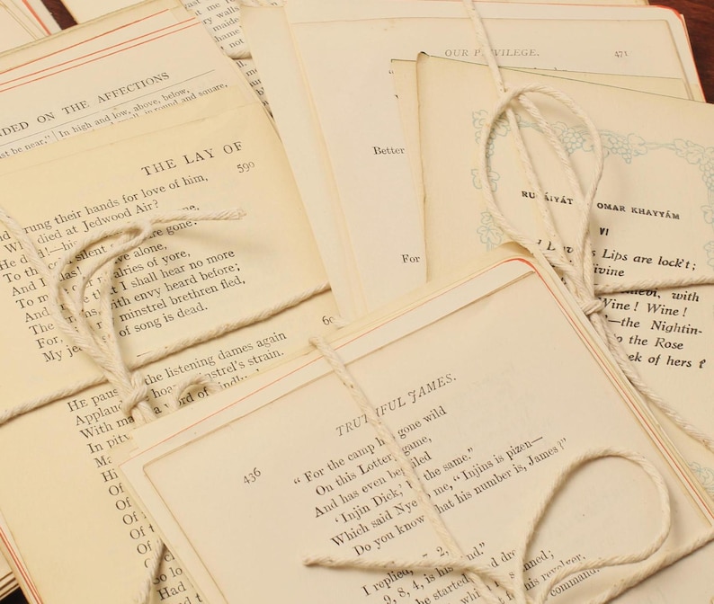 May include: A stack of vintage books tied together with twine. The books have various titles and text, including "The Lay of", "Our Village", "Ru Kiyat Omar Khayyam", and "Trutiful James".