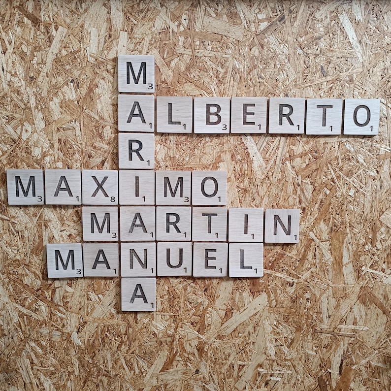 May include: A wooden board with the names "Alberto", "Maximo", "Martin", and "Manuel" spelled out in letter tiles.