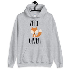 May include: A gray hoodie with a fox illustration and the text "ZERO GIVEN" printed on the front.