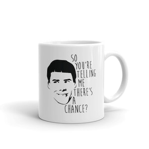 May include: White ceramic mug featuring a black and white illustration of a man's face and the text "SO YOU'RE TELLING ME THERE'S A CHANCE?". The mug has a curved handle and is suitable for hot or cold beverages.