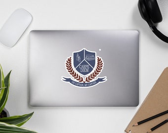 May include: A blue and brown sticker with a crest featuring a book, candles, and a laurel wreath. The text "CARPE DIEM" is written in white on a blue shield. The text "OH CAPTAIN, MY CAPTAIN." is written on a brown banner.