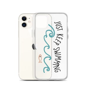 May include: A clear phone case with a teal wave design and the text "JUST KEEP SWIMMING". A small orange fish is swimming in the wave.