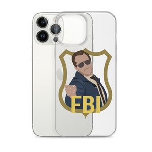 May include: Clear iPhone case featuring a cartoon illustration of a man in sunglasses pointing, with the letters "FBI" in gold. The design is set against a gold shield.