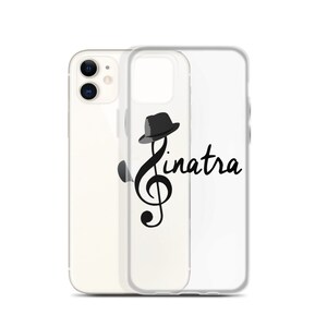 May include: A clear phone case with a black and white illustration of a treble clef with a hat on top. The text "Sinatra" is written next to the clef.
