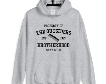 May include: Gray hooded sweatshirt with the text "Property of The Outsiders Est 1983 Brotherhood Stay Gold" and a comb graphic.
