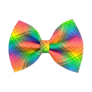 May include: A rainbow plaid bow tie with a bright yellow, orange, red, green, blue, and purple plaid pattern.