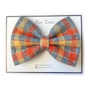 The finished bow tie is neatly packaged on a white post card with Paw Town branding on it.