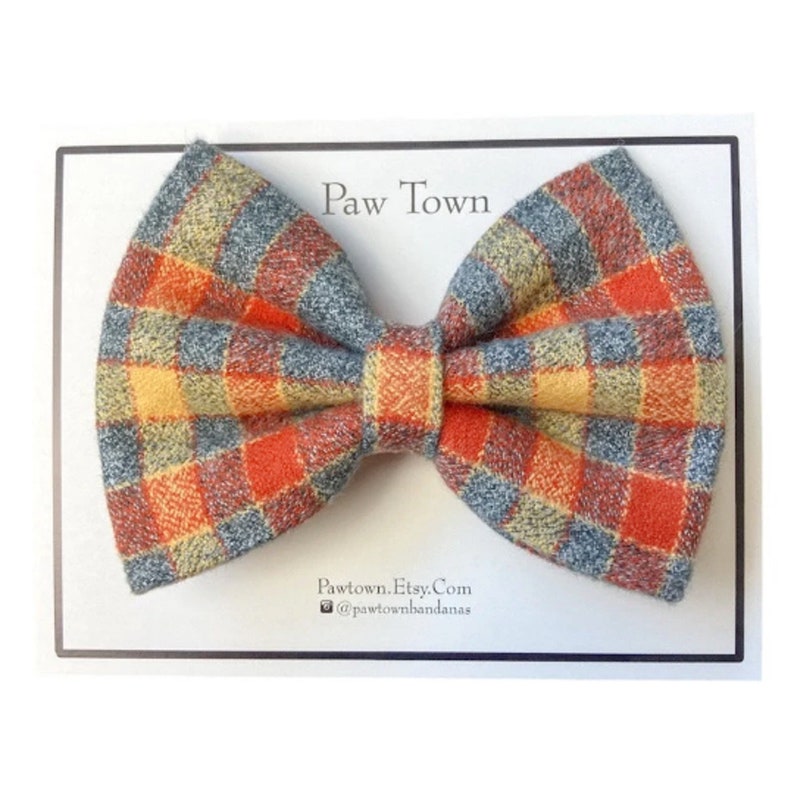 The finished bow tie is neatly packaged on a white post card with Paw Town branding on it.