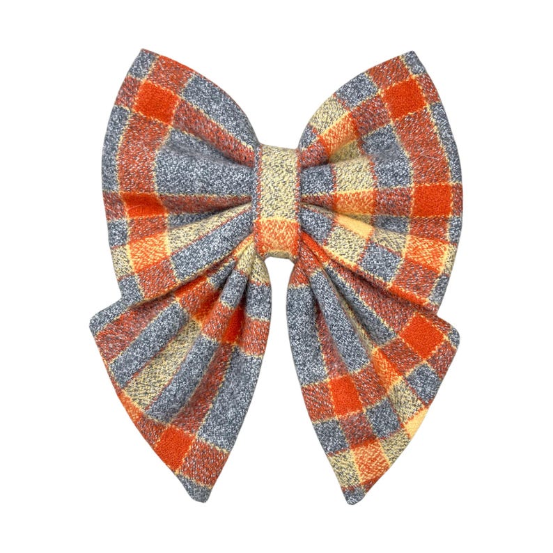 Orange and gray plaid dog bow tie or cat bow tie on a white background. Two Velcro straps are sewn on to the back.
