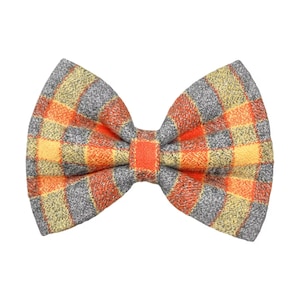 Orange and gray plaid dog bow tie or cat bow tie on a white background. Two Velcro straps are sewn on to the back.