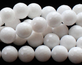 May include: A close-up of a strand of white gemstone beads. The beads are round and have a faceted finish.