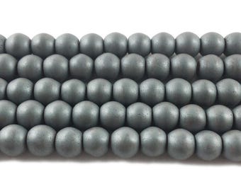 May include: Close-up of strands of grey wooden beads. The beads are round with a matte finish. The beads are strung together, creating a textured surface. These beads are suitable for jewellery making and craft projects.